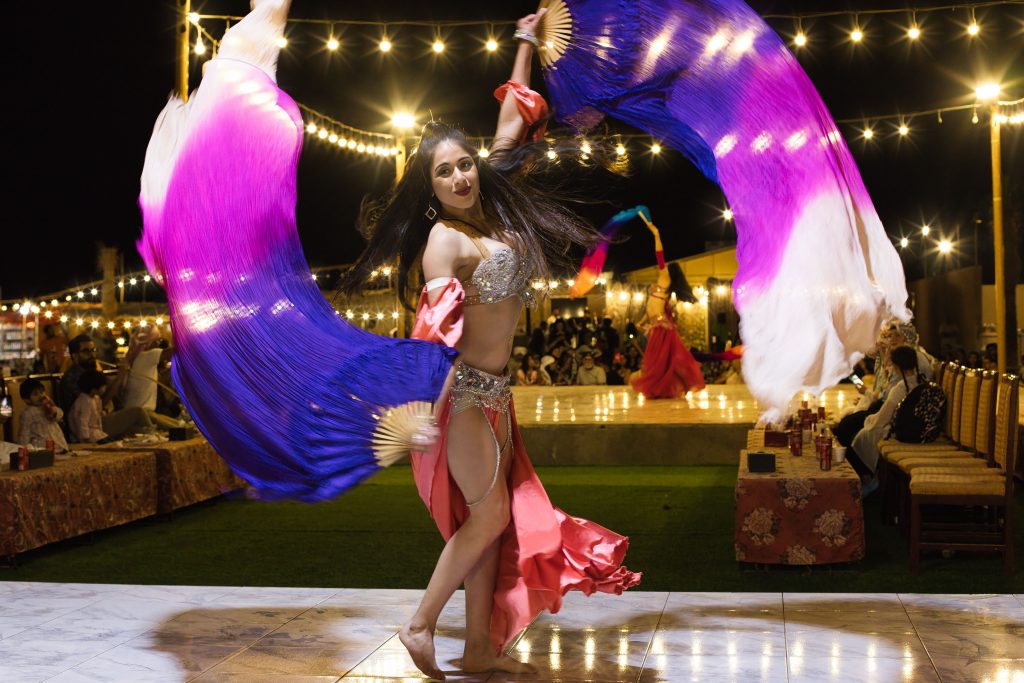 Vibrant belly dancing show under lights in Dubai, UAE.
